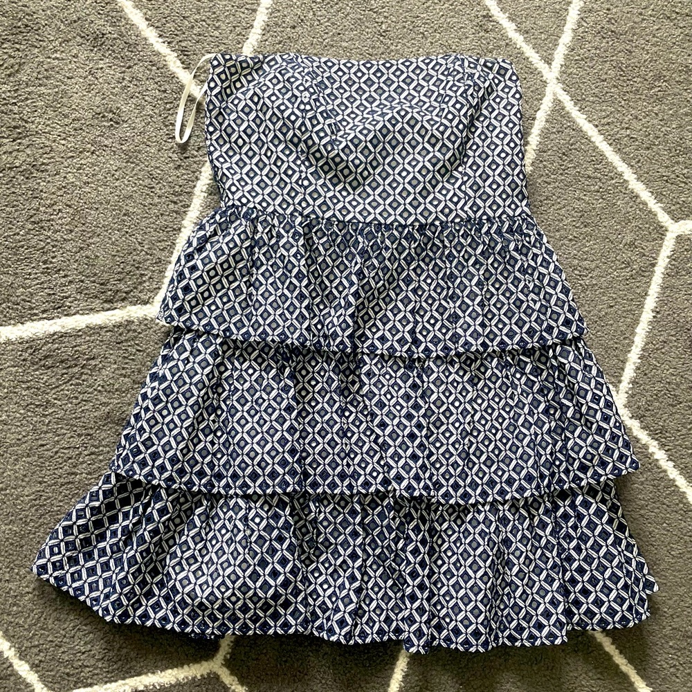 Navy blue and white tiered strapless mini dress with boning